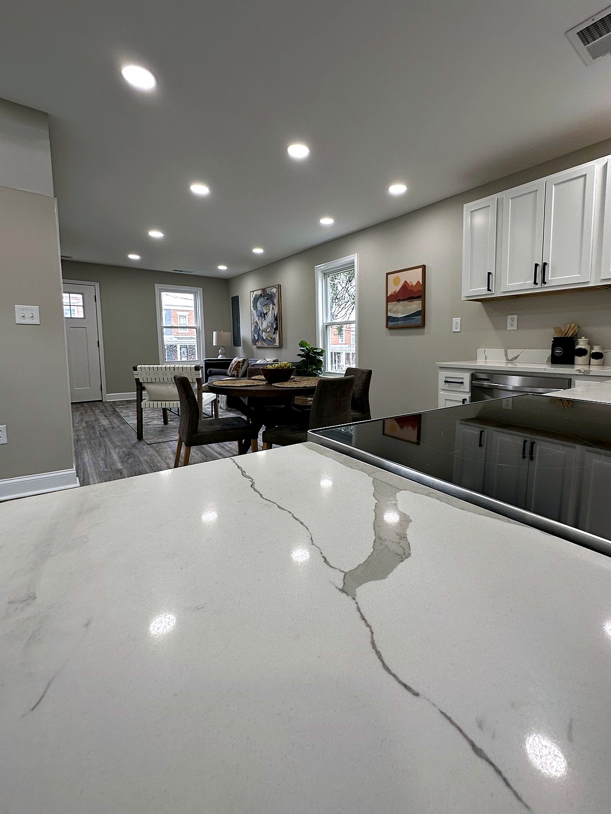 Quartz countertop looking into an open kitchen and dining area